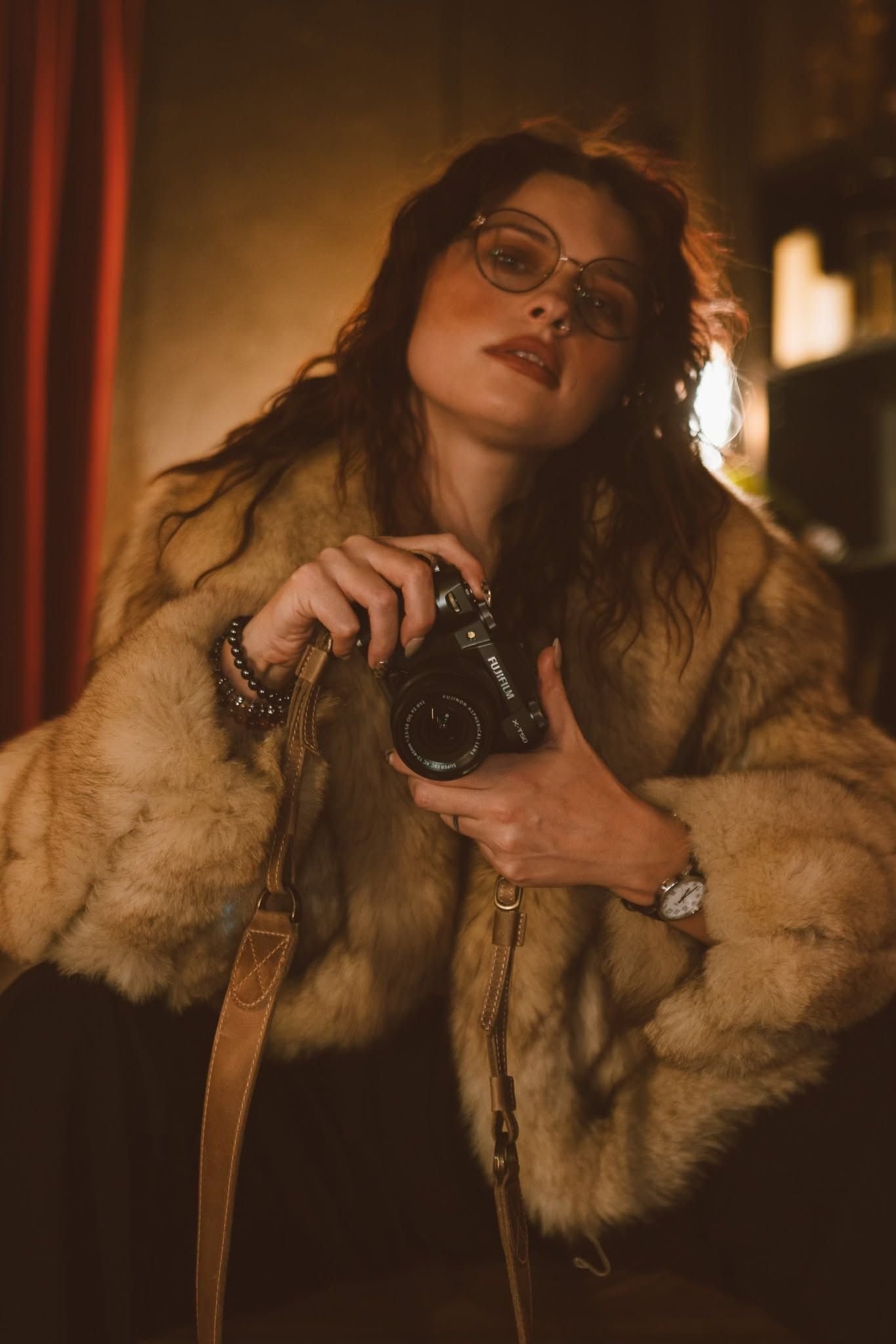 AJ of Wild Moon Boudoir Studios holding a Fujifilm camera