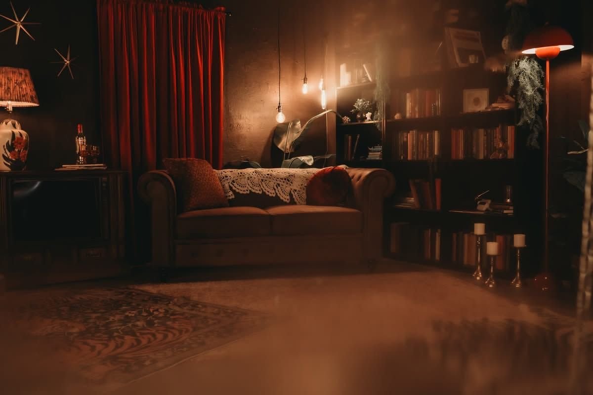 Wild Moon Boudoir Studios — warm, moody studio space with velvet couch and Edison bulbs